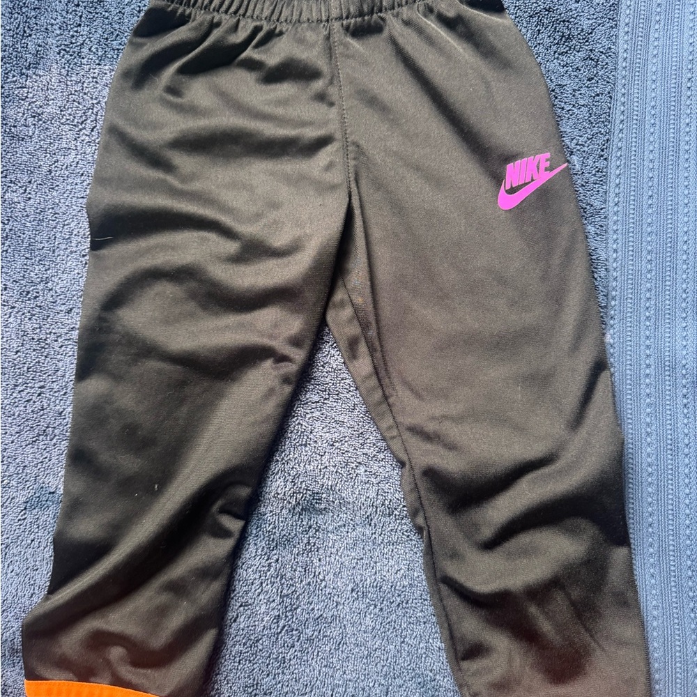 Nike Kids Black Jogger Bottoms with Pink Swoosh Logo